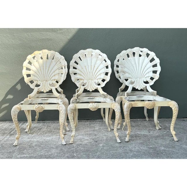 This striking set of six vintage grotto chairs showcases a whimsical marriage of natural form and classical elegance, each...