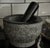 A substantial 1960s charcoal-granite mortar & pestle with the kind of weight, form, and sculptural presence that elevates...