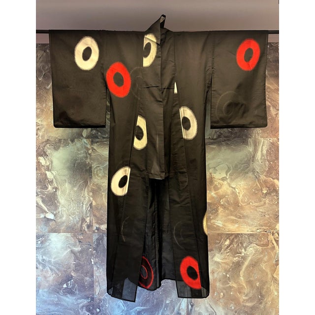 A Japanese formal Kimono made with a very fine black linen gauze augmented with applied modern circle pattern. The garment...