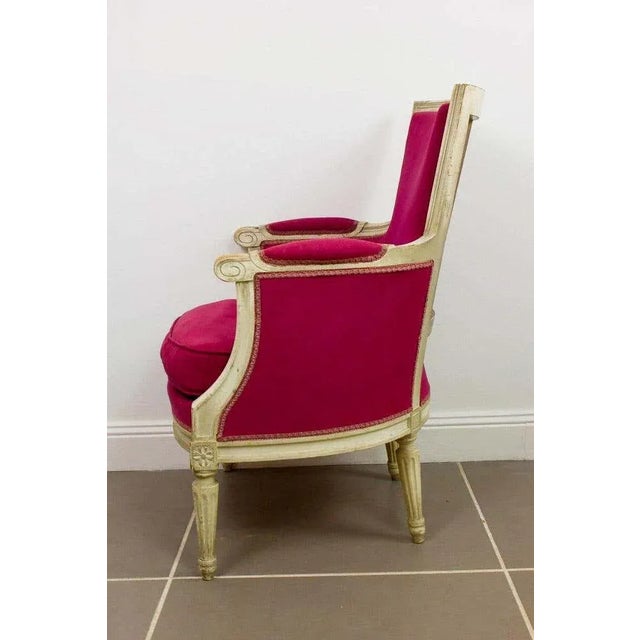 Charming Louis 16 style red "bergere" armchair from the Napoleon III period. The white lacquered frame with a beautiful...