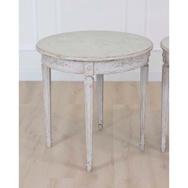 Made in Sweden in the twentieth century, this pair of round tables features carvings and decorative detail. The round tops...
