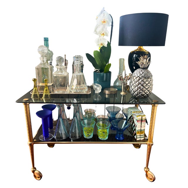 Elegant, understated and endlessly versatile, this vintage two-tier bar cart perfectly captures the glamour of the...