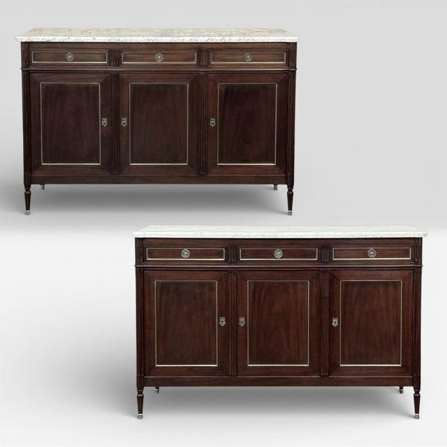 This refined French Louis XVI mahogany buffet with Carrara marble top makes a handsome and enduring addition to any...