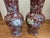 These matched floor vases feature an elegant, elongated baluster silhouette with flaring trumpet necks, tapering bodies,...