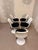 Tulip chairs by Rudi Bonzanini from the mid-20th century, featuring an elegant white frame and black upholstered seat....