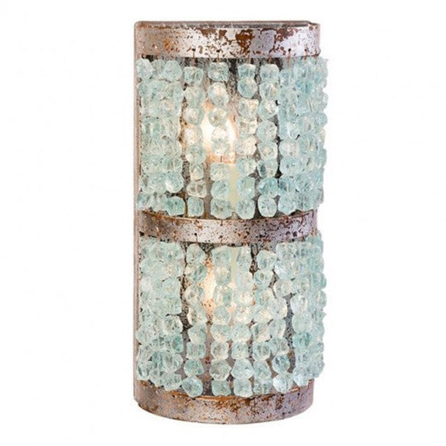 The aqua tones in this rounded sconce are created by a colorful palette of quartz crystal nuggets. The fixture is...