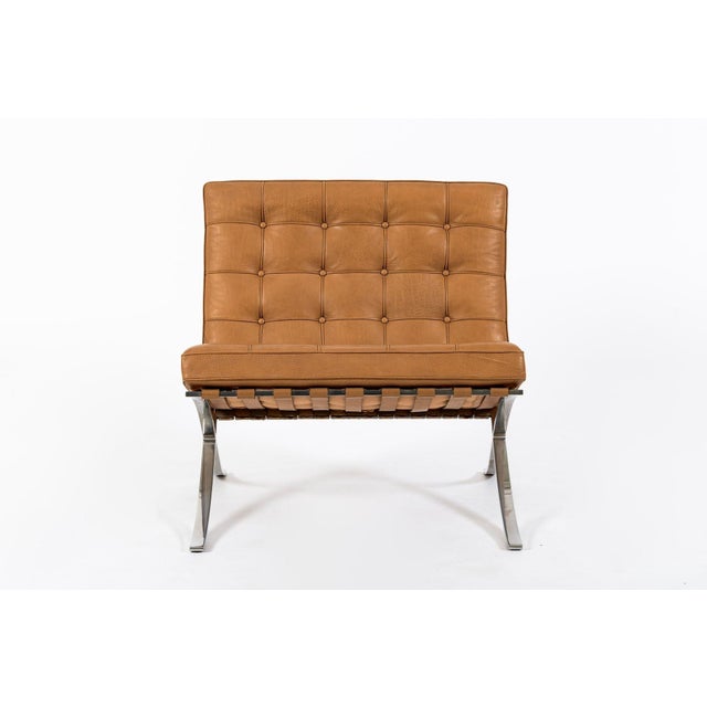 This vintage mid century modern brown leather Barcelona chair designed by Mies van der Rohe for Knoll was manufactured in...