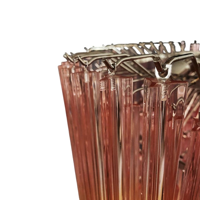 Contemporary Italian chandelier crafted with elongated pink Murano glass rods and a polished chrome structure....
