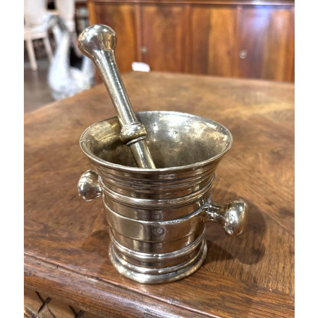 This handsome antique mortar and pestle combines substantial weight, sculptural form, and the practical character of...
