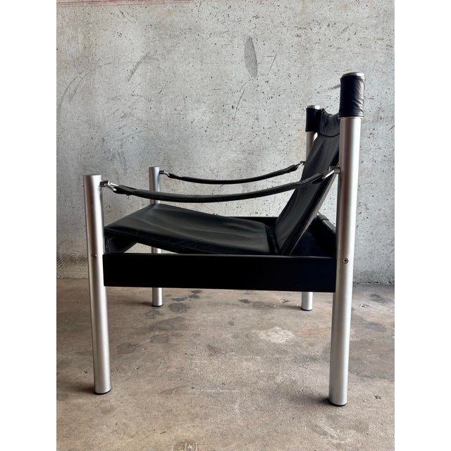 A refined expression of Swedish modern design, this safari lounge chair by Börje Johanson pairs architectural restraint...