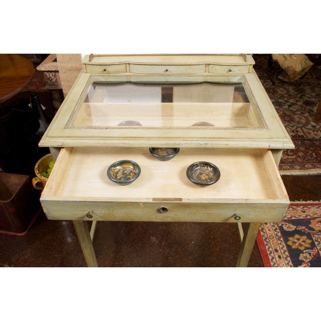 Painted Collector’s Display Table, painted pale green, brass gallery, French circa 1880 height: 37 in. (94 cm) width: 28...