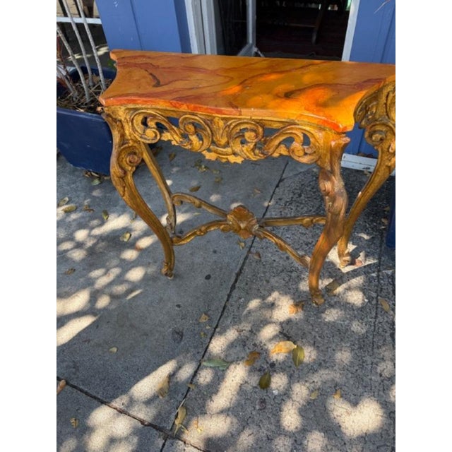 The product is an antique Italian Faux marble top console table with a serpentine front. It is fully assembled and made of...