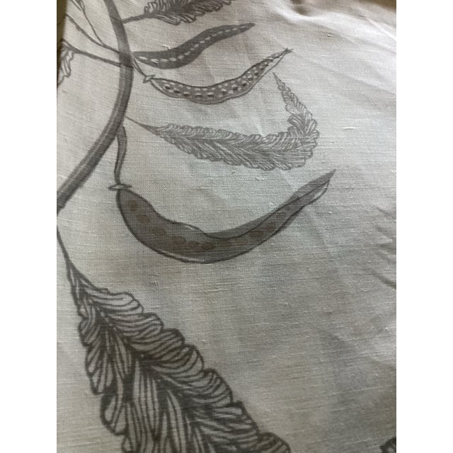 This fabric features a botanical print with stylized leaves and seed pods in brown and beige tones.