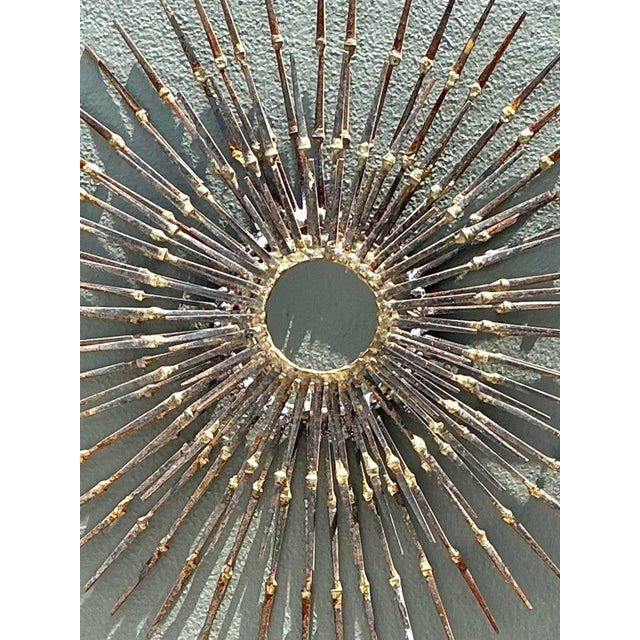 This striking sunburst wall sculpture is a quintessential example of Mid-Century Modern and Brutalist design. Handcrafted...