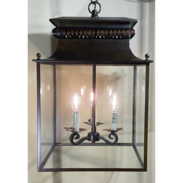 This elegant zinc lantern pendant is a stunning addition to any room in the house. Its intricate design features a square...