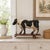 A WHIMSICAL CARVED AND PAINTED FOLK ART HOLSTEIN COW PULL TOY American, circa second half of the 20th Century Carved...