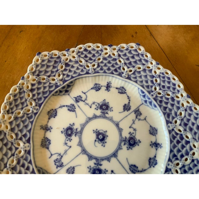 Reticulated rim features hand pierced double lace design embellished with fish scale accents. Distinct hexagonal design...