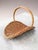 Add a touch of rustic farmhouse charm and texture to your space with this versatile 1970s vintage woven wicker gathering...