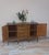 Classic 1950s style wooden sideboard. It features four central drawers with ornate bronze handles and two large side doors...