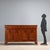 Walnut and crotchet sideboard. Pair of drawers in the molded band below the top, four paneled doors, and curved bracket...
