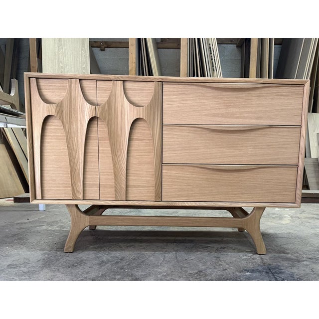A sculptural statement piece handcrafted in LA, this 55” White Oak “Brasilia” Single Sink Vanity blends architectural...
