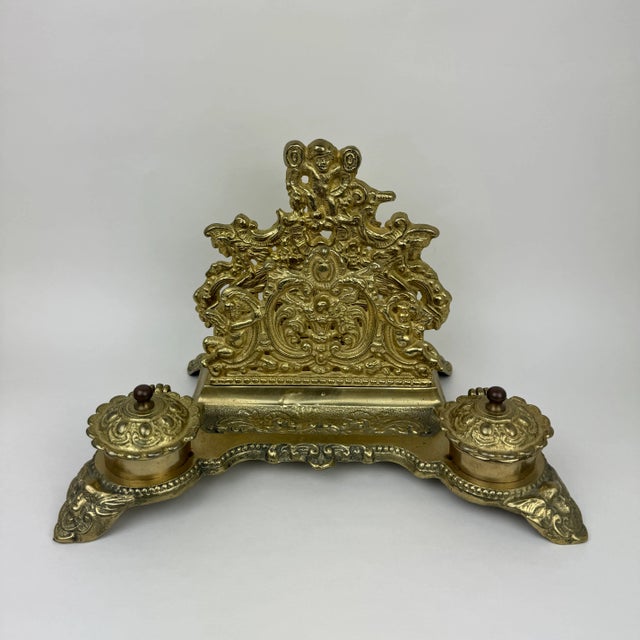 Stunning desk set featuring two inkwells with metal inserts, a letter holder, and a pen dish. This stunning piece was...