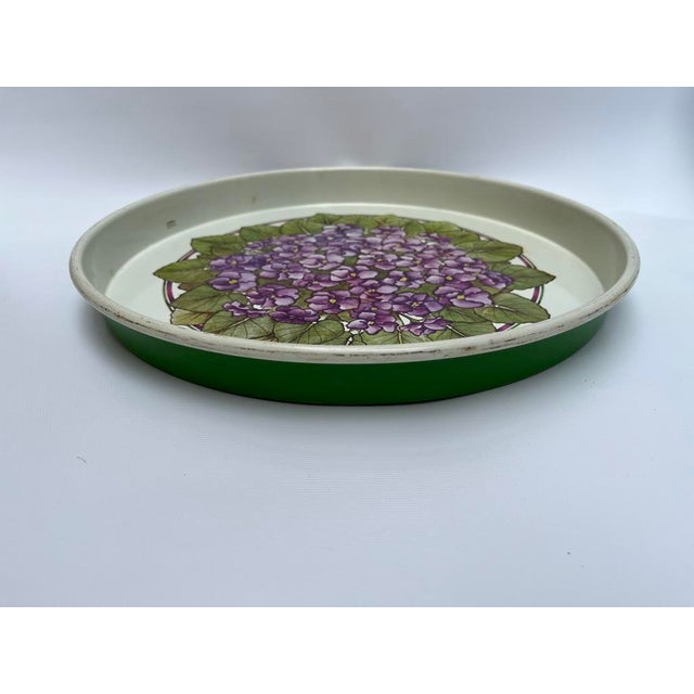 A single vintage round metal serving tray featuring a green back and painted purple hydrangea decoration.