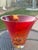 This is a hand-blown Evolution by Waterford red and amber art glass bowl featuring a vibrant, fiery swirled pattern....