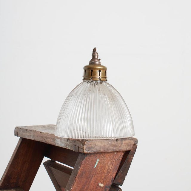 A vintage bell shaped glass prismatic pendant light shade which looks great both lit and unlit. The light has retained its...
