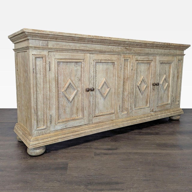 Washed grey finish buffet with molded paneled front, diamond panel on doors, interior shelving and bun feet. Dimensions...