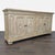 Washed grey finish buffet with molded paneled front, diamond panel on doors, interior shelving and bun feet. Dimensions...