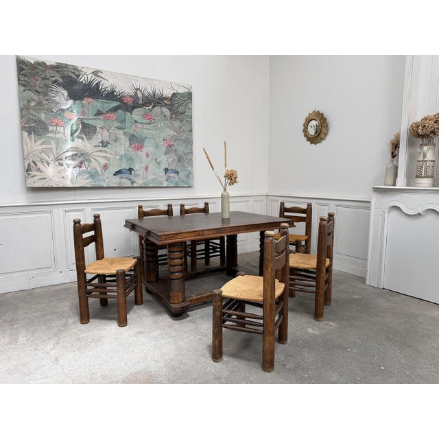 Solid oak dining table attributed to Charles Dudouyt, a renowned French cabinetmaker and designer of the 1920s and 1930s....
