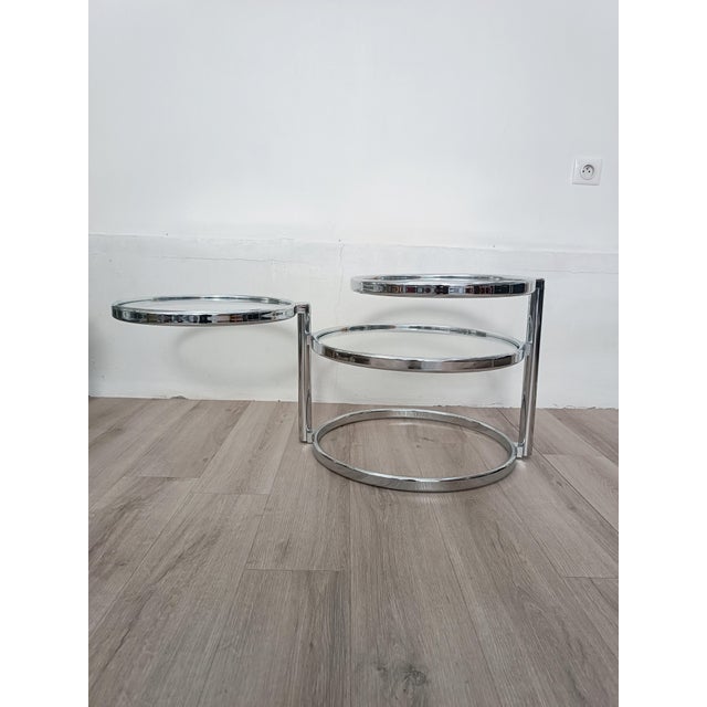 Beautiful 1980s side table. Chrome-plated metal frame. Fixed main shelf. The two upper shelves rotate 360 ​​degrees....