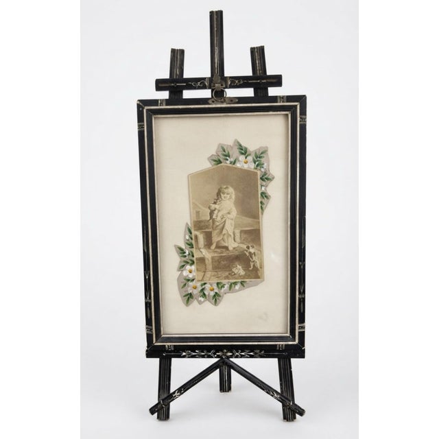 An exquisite circa 1850 Victorian ebonized wood tabletop easel frame, expertly crafted to mimic luxury inlaid materials of...