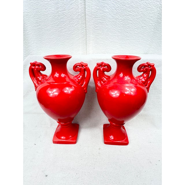 Fabulous pair of urns. A bright vibrant red color. Perfect to use with flowers on a mantle or as decorative accents. These...