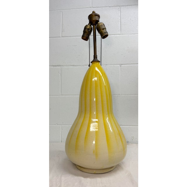 Up for sale is an exquisitely large antique French yellow gourd shaped pottery table lamp. It is done in a lovely yellow...