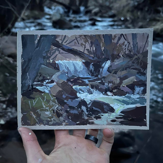 Eventide Falls captures a serene moment by a gentle waterfall, where soft light filters through the surrounding trees,...