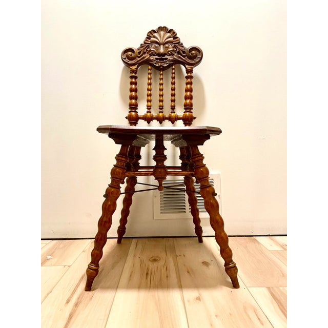 A piece that will draw everyone's attention- an antique "North Wind chair" or "green man chair" with bobbin spindles. We...
