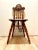 A piece that will draw everyone's attention- an antique "North Wind chair" or "green man chair" with bobbin spindles. We...