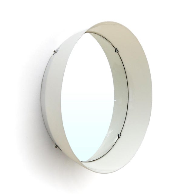 Italian manufacturing mirror produced in the 70s. Printed white plastic cylindrical structure. Circular mirror blocked by...