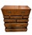 A vintage campaign-style dresser in warm wood with recessed brass pulls and brass corner brackets. Flush drawer fronts,...