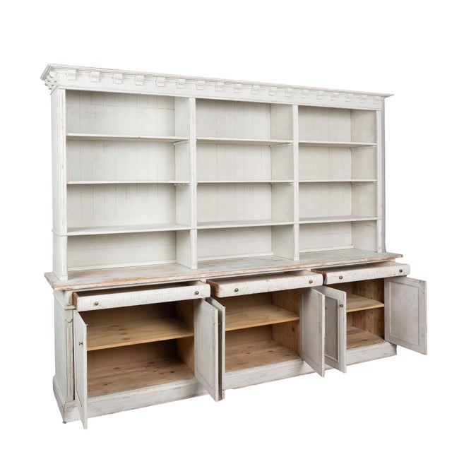 19th century large Danish bookcase, crafted in pine. This large display cabinet features removable shelves and offers...