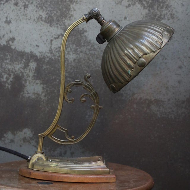 Art nouveau brass table desk lamp with brass shade and wooden base. Ca. 1920 natural aged with small cracks in edge shade...