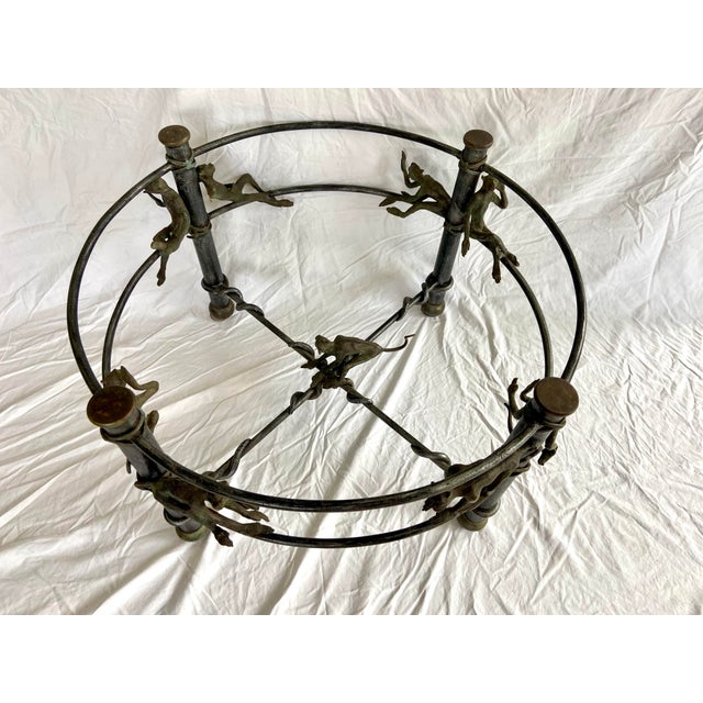 .Maitland-Smith "Monkeying Around" cast bronze coffee table base. This unique piece features a sturdy frame adorned with a...