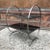 Art Deco, side table featuring looped, etched steel frame with two tiers of black glass; lower shelf is 10" HT and upper...