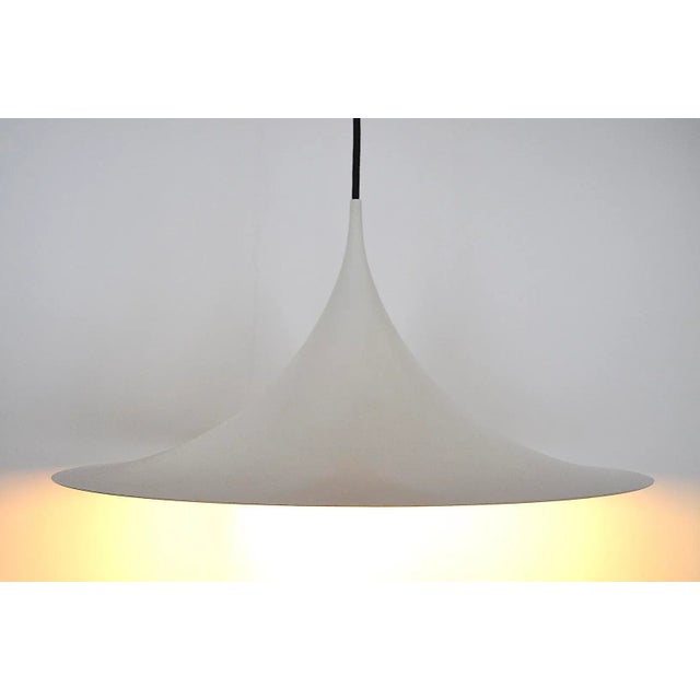 This semi pendant light was designed in 1967 from the architects and designers Claus Bonderup & Torsten Thorup for the...