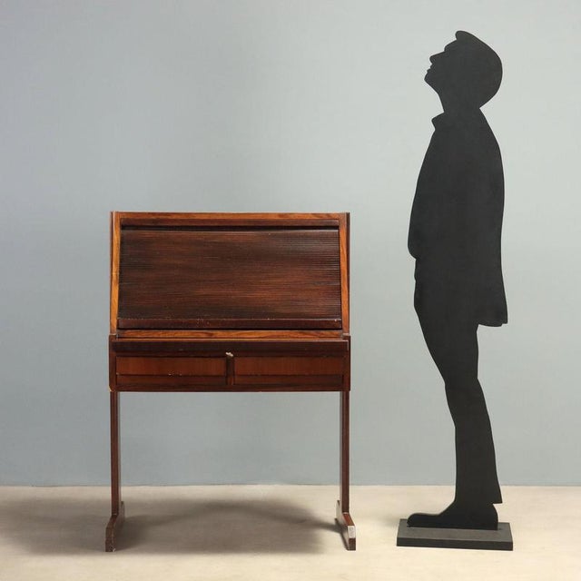 1960s tambour roll-top desk crafted from exotic wood veneer. The functional design features a retractable pull-out top,...