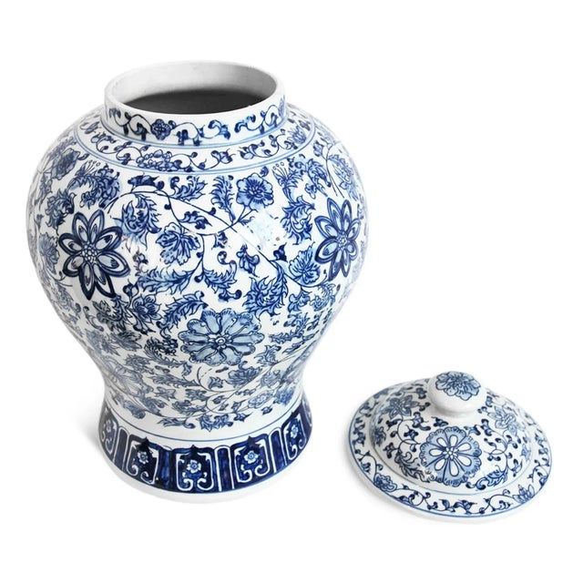 Traditional blue and white porcelain urn with intricate hand painted floral design. Includes removable lid with knob on...