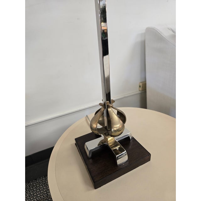 Hollywood Regency style characterized by sculptural open -cage brass finials on the stem and base.