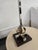Hollywood Regency style characterized by sculptural open -cage brass finials on the stem and base.